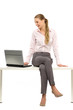 Woman sitting on table with laptop