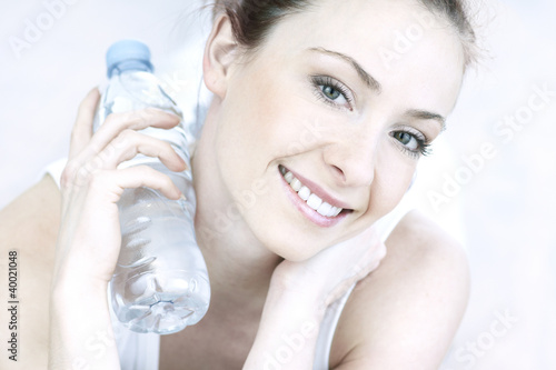 Photo: portrait of young woman with bottle portrait of young woman with bottle