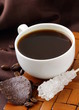 small cup of coffee espresso on a brown background