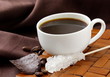 small cup of coffee espresso on a brown background