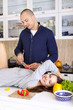 Portrait of a smiling couple preparing food together at home