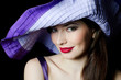Portrait of the beautiful elegant woman in a lilac hat Portrait of the beautiful elegant woman in a lilac hat