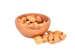 Apricot stone in wooden bowl on white background