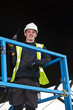 portrait of standing construction worker holding electric tool