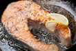 Appetizing salmon steak on a frying pan