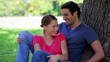 Video: Happy couple hugging while leaning against a tree Happy couple hugging while leaning against a tree