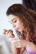 .Young woman eating yogurt