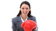 Businesswoman boxing with red gloves