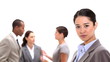 Businesswoman standing with co-workers behind her
