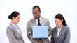 Businessman using a laptop while talking with colleagues