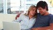 Lovely couple looking at a laptop