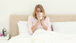 Smiling blonde woman drinking a tea