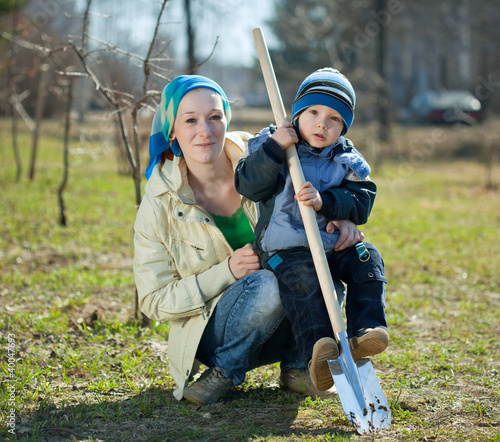 Photo: woman and boy with spade woman and boy with spade