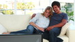 Smiling couple sitting on the sofa