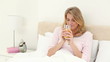 Smiling woman drinking an orange juice