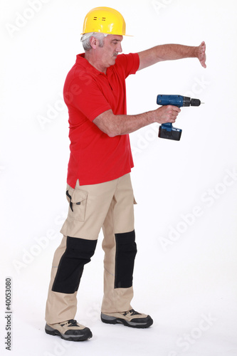 Photo: Tradesman using a power tool Tradesman using a power tool