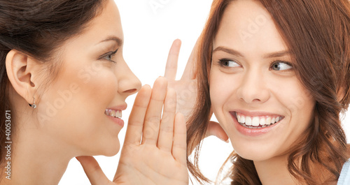 Photo: two women spreading gossip two women spreading gossip