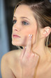 Woman applying cream on your face