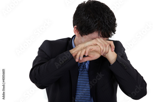 Photo: Man hiding his face in shame Man hiding his face in shame