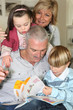 An elderly couple spending time with their grandchildren