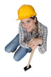 Pretty woman posing with sledge hammer