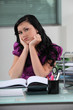 Woman behind her desk