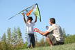 Father and son playing with a kite
