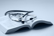 A medical stethoscope on an open book, blueprint A medical stethoscope on an open book, blueprint