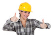 Smiling tradeswoman giving two thumb's up