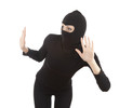 female thief in black clothes looking through the window
