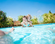 Happy family playing in swimming pool