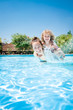 Happy child playing with mother in pool