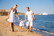 Happy family playing at the beach Happy family playing at the beach