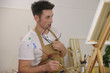 artist painting model at art studio