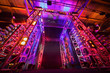 Multi-colored illuminated way to boxing ring inside fight club;
