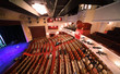 People sit down before concert in empty concert hall