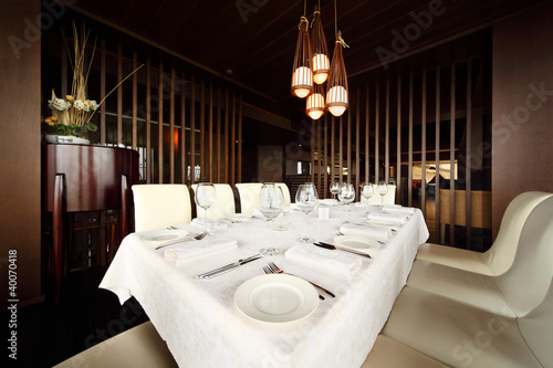 Photo: beautiful serving at table with white tablecloth in restaurant; beautiful serving at table with white tablecloth in restaurant;