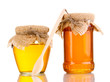 Sweet honey in jars with spoon isolated on white Sweet honey in jars with spoon isolated on white