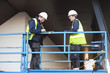 Foreman and construction worker at constraction site