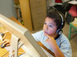 Little Boy Working and Thinking at the Computer at Home