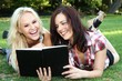 Beautiful Young Women Friends Reading Outdoors Beautiful Young Women Friends Reading Outdoors