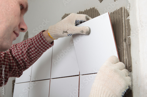 Photo: Contractor installing tiles Contractor installing tiles