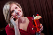 Attractive young woman with a drink at a nightclub