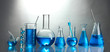 Test-tubes with blue liquid on grey background