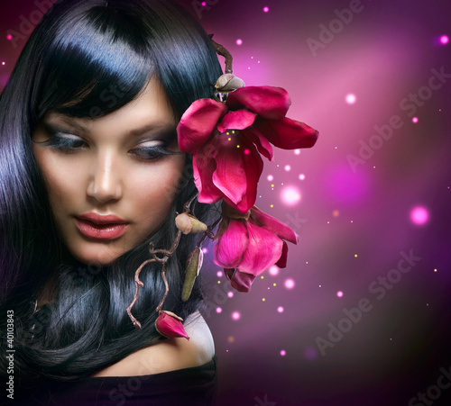 Photo: Fashion Brunette Girl with Magnolia Flowers Fashion Brunette Girl with Magnolia Flowers