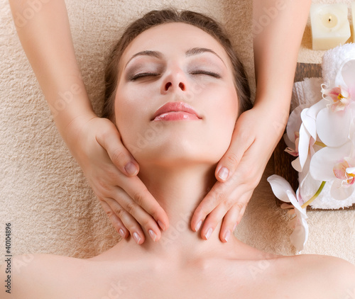 Photo: Spa Massage. Young Woman Getting Facial Massage Spa Massage. Young Woman Getting Facial Massage