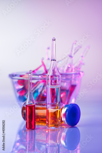Photo: Medical ampoules still life in vivid violet colors Medical ampoules still life in vivid violet colors