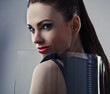 Young beautiful brunette pose in a fashionable dress.
