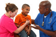 Pediatrician and Nurse With Young Black Child