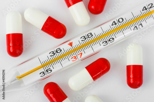 Photo: Thermometer and pills Thermometer and pills